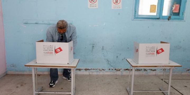 A man votes at a polling station during parliamentary election in Tunis, Tunisia.