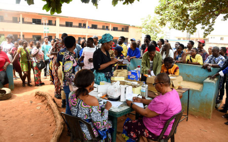 Officials of the Independent National Electoral Commission (INEC) sit to distribute Permanent Voter Cards to prospective voters at a ward in Lagos on 13 January 2023 ahead of the 25 February presidential election. Picture: PIUS UTOMI EKPEI / AFP