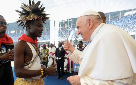 This handout photo taken and released on 2 February 2023 by the Vatican Media shows Pope Francis (R) greeting an attendee during a meeting with young people and catechists at Martyrs' Stadium in Kinshasa, Democratic Republic of Congo. Picture: Vatican Media/AFP