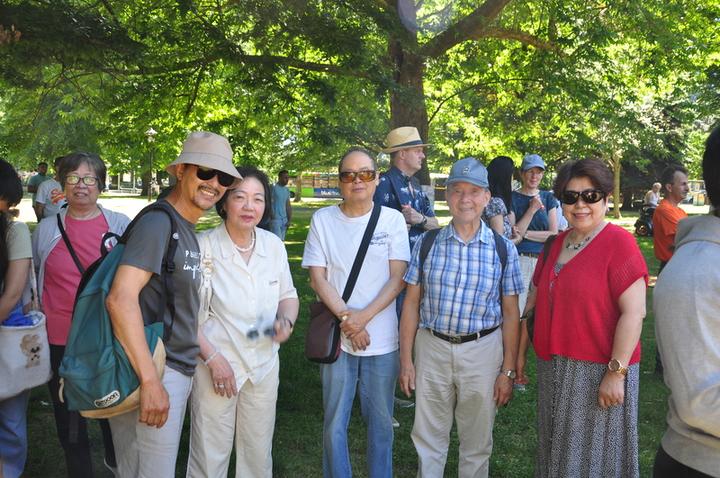 A group of people standing in a park

Description automatically generated with medium confidence