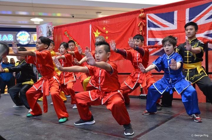 A group of young people performing martial arts

Description automatically generated