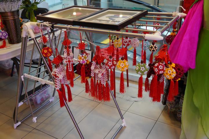 A display of red tassels and tasselsDescription automatically generated