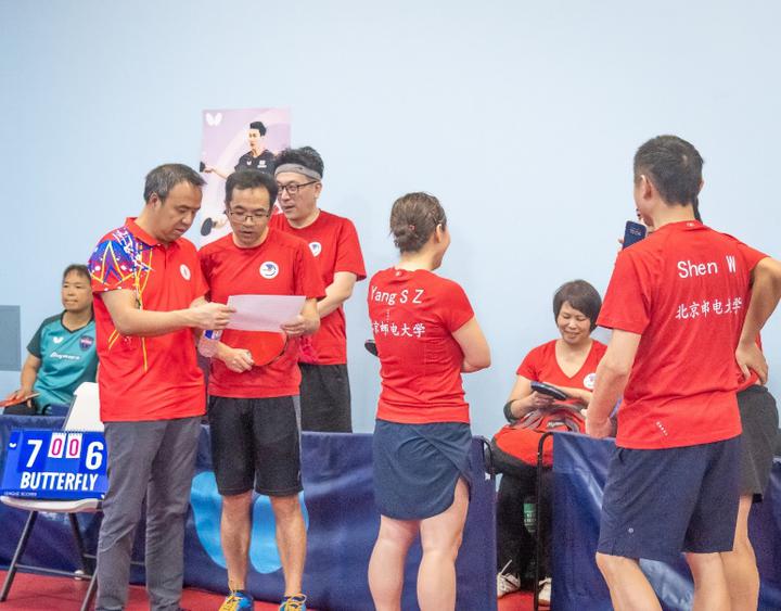 A group of people in red shirtsDescription automatically generated