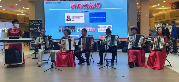 A group of people playing accordionsDescription automatically generated