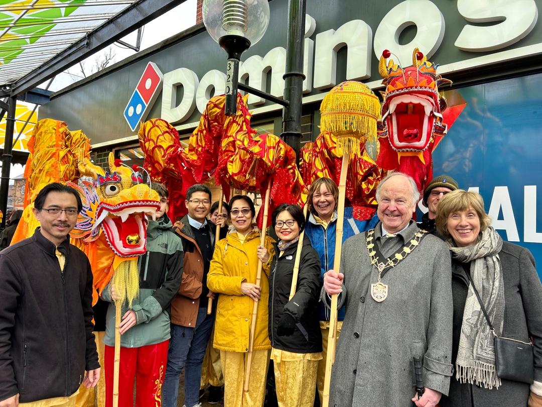 A group of people posing for a photo

Description automatically generated