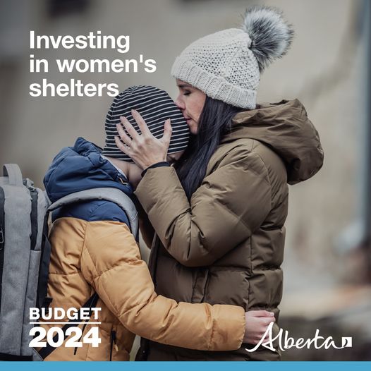 A woman kissing the top of her child’s head. Both are wearing winter coats and hats. Text reads Investing in women’s shelters. The budget 2024 watermark is in the bottom left corner. The Alberta government logo is in the bottom right corner.