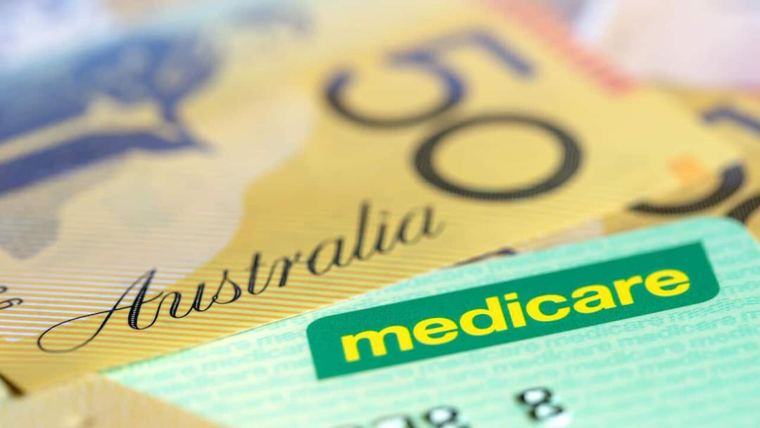Australian Medicare Card over Money.  Shallow focus, with copy space.