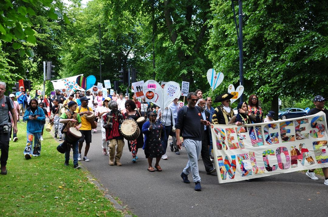 A group of people marching in a parade

Description automatically generated