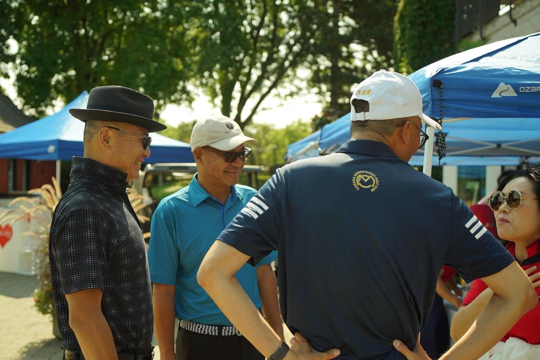 A group of men standing outsideDescription automatically generated