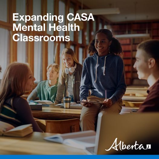 A group of students are chatting with each other in a library. The text reads Expanding CASA Mental Health Classrooms. The white Alberta logo is in the bottom right hand corner.