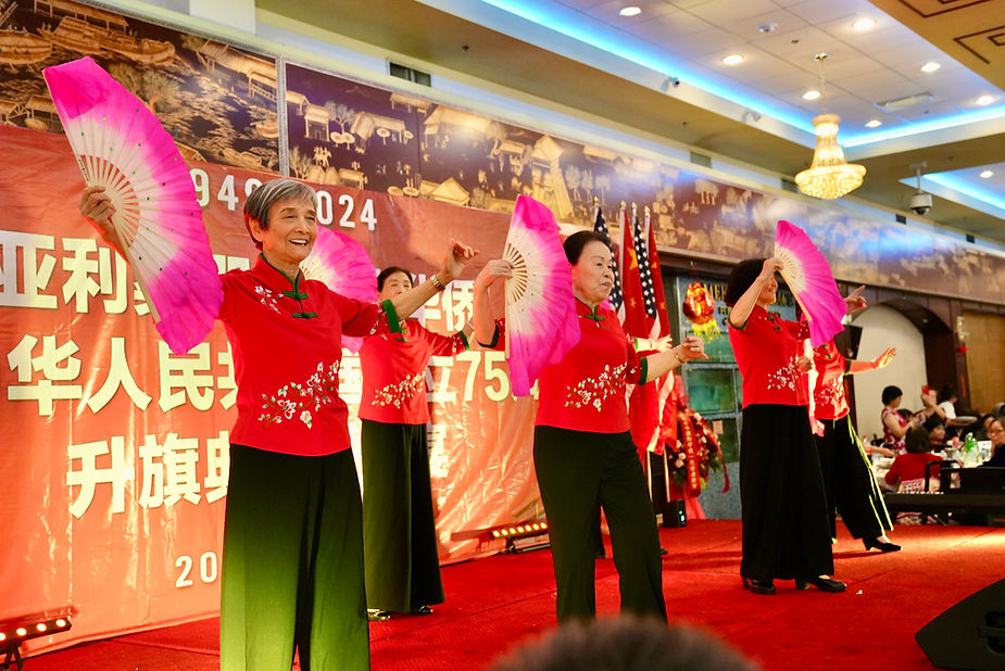 A group of women performing on a stage

Description automatically generated