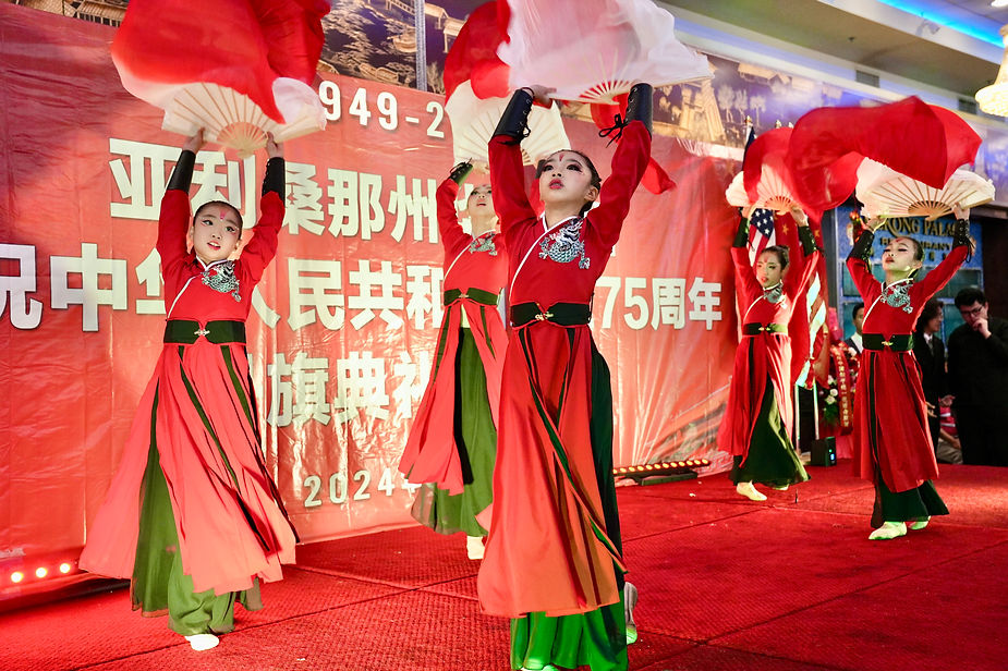 A group of girls dancing on a stage

Description automatically generated