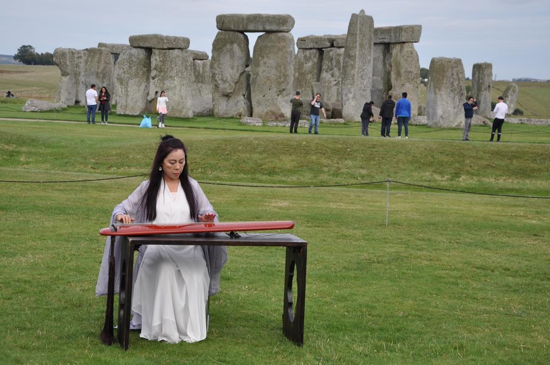 A person sitting at a table in a field

Description automatically generated