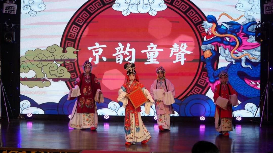 A group of people in traditional clothing on a stage

Description automatically generated