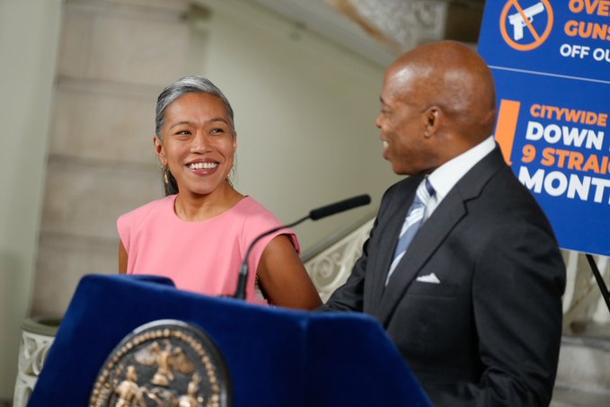 photo of mayor adams stand at podium looking to his side at deputy mayor torres-springer, both of them standing in city hall rotunda