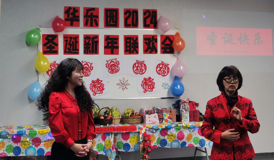 A group of women standing in front of a tableDescription automatically generated