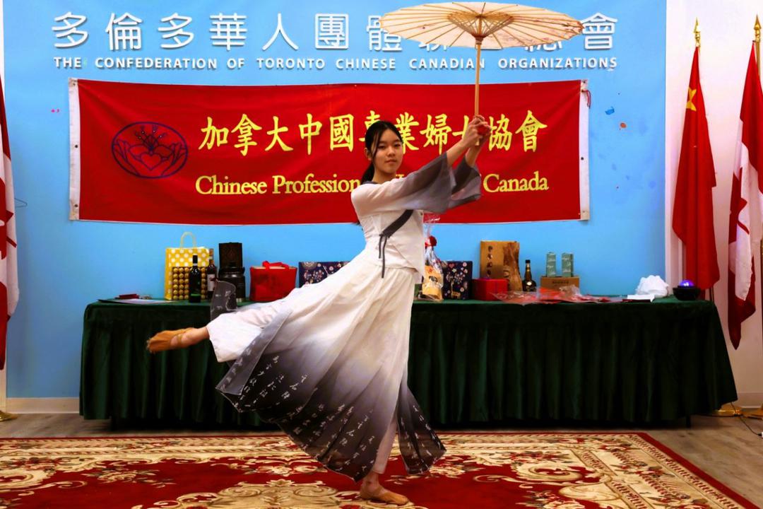 A person dancing with an umbrellaDescription automatically generated