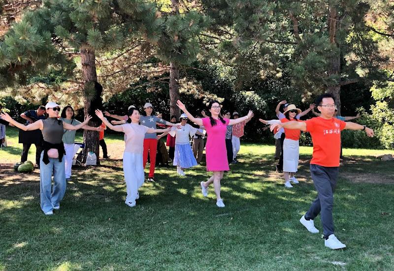 A group of people standing in a circle with their arms outAI-generated content may be incorrect.