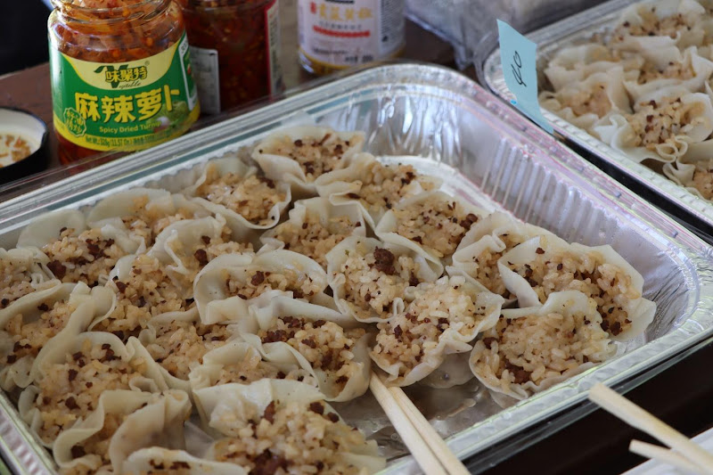 Food in a tray with chopsticksAI-generated content may be incorrect.