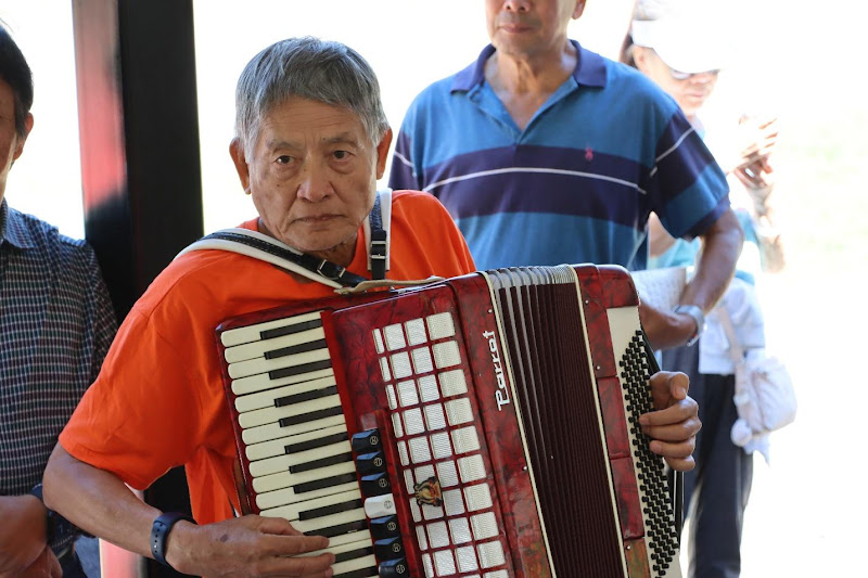 A person holding an accordionAI-generated content may be incorrect.