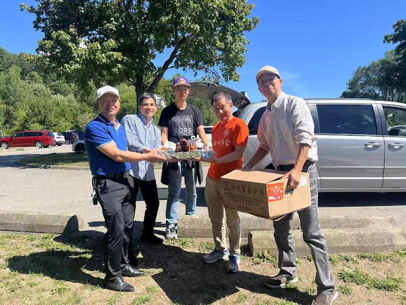 A group of people holding a box and a boxAI-generated content may be incorrect.