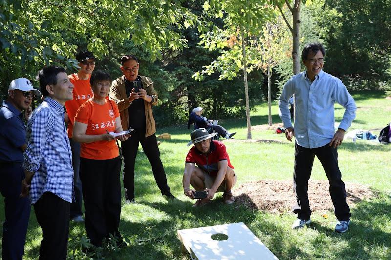 A group of people standing in a parkAI-generated content may be incorrect.