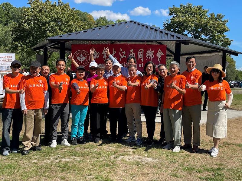 A group of people in orange shirtsAI-generated content may be incorrect.
