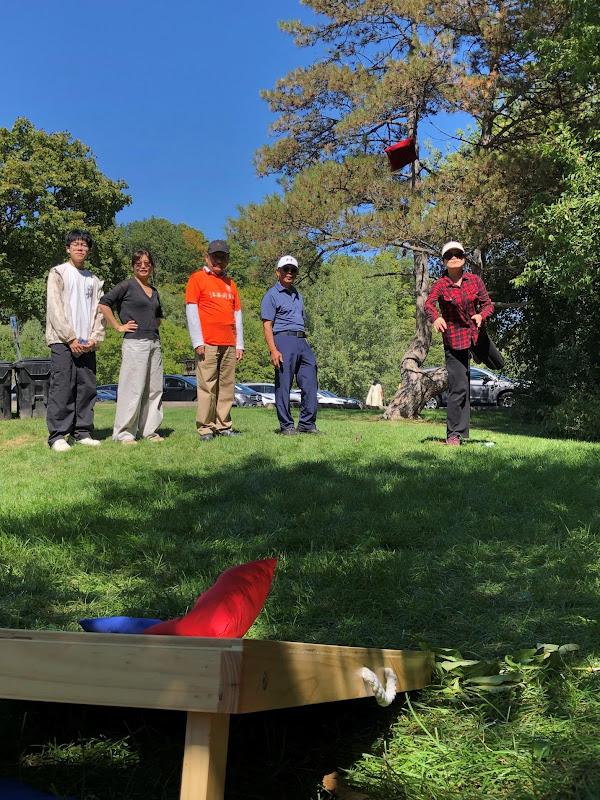 A group of people standing in a grassy areaAI-generated content may be incorrect.