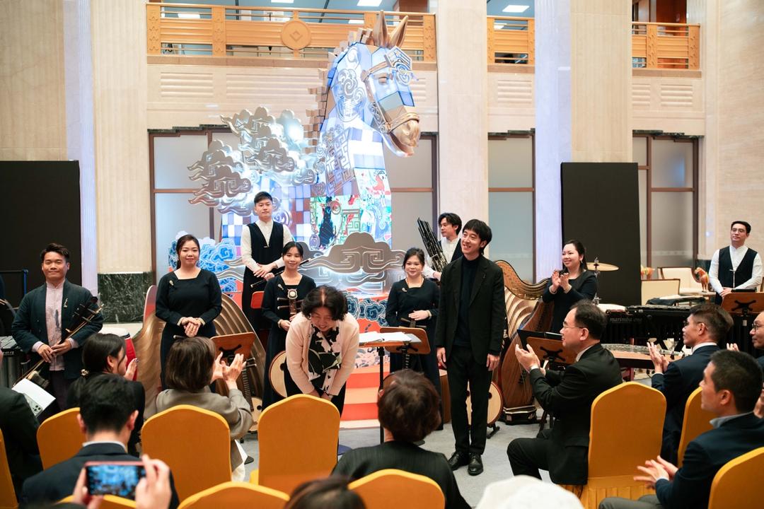 A group of people performing in a roomAI-generated content may be incorrect.